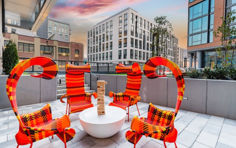 Outdoor courtyard with bright orange sculptural seating